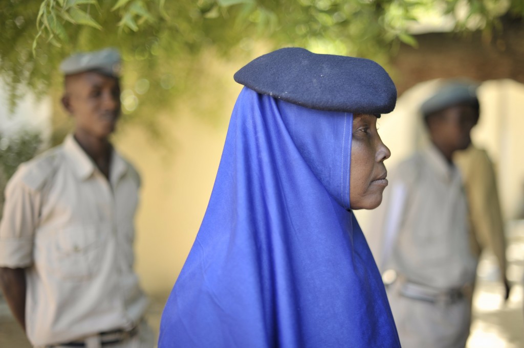 A female Somali police officer watches a training exercise taking place at General Kahiye Police Academy in Mogadishu, Somalia. The African Union Mission in Somalia (AMISOM) is currently training one hundred Somali Police officers in a program aimed at equipping the Somali Police Force with the necessary skills to effectively arrest suspects, stop vehicles at checkpoints, and cordon off areas.(June 2014)